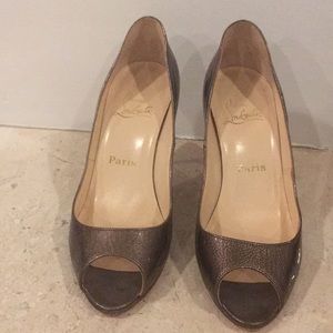 Christian Louboutin gold pumps